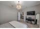 Bedroom with a stylish light fixture, neutral decor, piano and light wood flooring at 3527 101St E Ave, Parrish, FL 34219