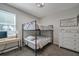 This bedroom offers a metal frame bunk bed, a desk and chair, and a chest of drawers at 3527 101St E Ave, Parrish, FL 34219