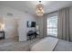 Bedroom with a stylish light fixture, neutral decor, piano and light wood flooring at 3527 101St E Ave, Parrish, FL 34219