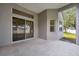 Covered patio with sliding glass doors and view of green backyard at 3527 101St E Ave, Parrish, FL 34219