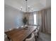 Elegant dining room with a long wooden table and modern chandelier at 3527 101St E Ave, Parrish, FL 34219