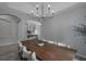 Elegant dining room with a long wooden table and modern chandelier at 3527 101St E Ave, Parrish, FL 34219