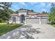 Beautiful single-story home featuring a three-car garage and meticulously maintained front yard at 3527 101St E Ave, Parrish, FL 34219