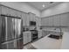 Modern kitchen featuring gray cabinets and stainless steel appliances at 3527 101St E Ave, Parrish, FL 34219