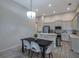 Modern kitchen with a dining area, stainless steel appliances and sleek countertops at 3527 101St E Ave, Parrish, FL 34219