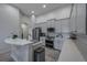 Spacious kitchen with stainless steel appliances, island and gray cabinets at 3527 101St E Ave, Parrish, FL 34219