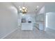 Open-concept kitchen with stainless steel appliances and breakfast bar at 3527 101St E Ave, Parrish, FL 34219