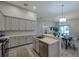 Open kitchen and dining area with white counters and dining table at 3527 101St E Ave, Parrish, FL 34219
