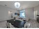 Open living room with wood floors, dining table and a light color palette at 3527 101St E Ave, Parrish, FL 34219