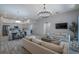 Open-concept living room featuring hardwood floors and seamless flow to the dining and kitchen areas at 3527 101St E Ave, Parrish, FL 34219