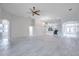 Spacious living room with neutral color palette, arched doorways, and a ceiling fan at 3527 101St E Ave, Parrish, FL 34219