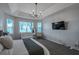 Bright bedroom with tray ceiling, and carpet flooring at 3527 101St E Ave, Parrish, FL 34219