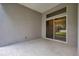 An open patio area features smooth concrete floors and a sliding glass door entrance at 3527 101St E Ave, Parrish, FL 34219