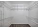 Spacious walk-in closet with multiple shelves and hanging rods for ample storage at 3527 101St E Ave, Parrish, FL 34219