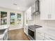 Bright kitchen featuring marble countertops, stainless steel appliances, and a view of the street through three windows at 4210 N Central N Ave, Tampa, FL 33603