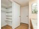 Bathroom with vanity, open closet, shelving and great lighting at 450 Treasure Island Cswy # 505, Treasure Island, FL 33706