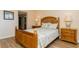 Inviting bedroom with wood furnishings, soft lighting, and serene decor at 450 Treasure Island Cswy # 505, Treasure Island, FL 33706