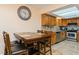 Cozy dining area with wooden table and chairs and access to a kitchen at 450 Treasure Island Cswy # 505, Treasure Island, FL 33706