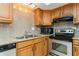 Galley kitchen featuring stainless steel appliances, granite countertops, and light wood cabinetry at 450 Treasure Island Cswy # 505, Treasure Island, FL 33706