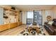 Bright living area with custom shelving, marble coffee table, and access to the balcony at 450 Treasure Island Cswy # 505, Treasure Island, FL 33706
