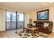Open living area with leather sofa and balcony with scenic views of surrounding area at 450 Treasure Island Cswy # 505, Treasure Island, FL 33706