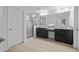 Bathroom featuring a walk-in shower with glass doors, double vanity with dark cabinets and wood-look tile flooring at 4528 Ballantrae Blvd, Land O Lakes, FL 34638