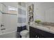 Bathroom featuring shower/tub, decorative curtain, decorative artwork, and granite sink at 4528 Ballantrae Blvd, Land O Lakes, FL 34638