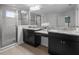 Well-lit bathroom with granite countertops, walk-in shower, and modern sinks at 4528 Ballantrae Blvd, Land O Lakes, FL 34638