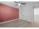 Spacious bedroom with ceiling fan, warm accent wall, and closet for ample storage at 4528 Ballantrae Blvd, Land O Lakes, FL 34638