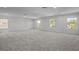 Spacious bonus room filled with natural light streaming in through multiple windows, and plush carpet throughout at 4528 Ballantrae Blvd, Land O Lakes, FL 34638