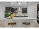 Modern kitchen featuring a large island with seating and stainless steel appliances and a stylish backsplash at 4528 Ballantrae Blvd, Land O Lakes, FL 34638