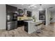 Modern kitchen boasts stainless steel appliances, dark cabinets, a center island with seating, and stylish pendant lighting at 4528 Ballantrae Blvd, Land O Lakes, FL 34638