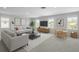 Bright living room featuring modern furnishings and neutral tones, complemented by large windows for ample natural light at 4528 Ballantrae Blvd, Land O Lakes, FL 34638