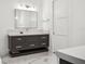 The bathroom has a large vanity with modern fixtures, and elegant marble flooring at 5009 W Longfellow Ave, Tampa, FL 33629