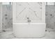 Modern bathroom with a soaking tub, marble tile and dual showerheads, offering a luxurious and spa-like experience at 5009 W Longfellow Ave, Tampa, FL 33629