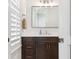 Elegant half bathroom featuring a modern vanity, sleek mirror, and bright lighting at 5009 W Longfellow Ave, Tampa, FL 33629