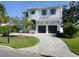 Beautiful two-story home with a paved driveway, two-car garage and manicured lawn at 5009 W Longfellow Ave, Tampa, FL 33629