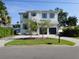Inviting two-story home with a well-manicured lawn and a two-car garage at 5009 W Longfellow Ave, Tampa, FL 33629