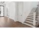 Welcoming foyer features hardwood floors, an elegant staircase, and modern lighting at 5009 W Longfellow Ave, Tampa, FL 33629