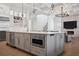 This modern kitchen features a large island with built-in appliances and open layout to the living area at 5009 W Longfellow Ave, Tampa, FL 33629