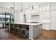 This spacious kitchen features a large island with seating and modern white cabinets and lighting at 5009 W Longfellow Ave, Tampa, FL 33629