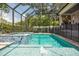 Inviting screened-in pool with a hot tub and lush tropical landscaping, creating a private outdoor oasis for relaxation at 5009 W Longfellow Ave, Tampa, FL 33629