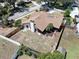 Aerial view of a home featuring a fenced backyard and a brown roof with a chimney and skylights at 501 Sportsman Park Dr, Seffner, FL 33584