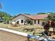 Cozy home with a well-manicured yard featuring a variety of ornamental plants and shrubs at 501 Sportsman Park Dr, Seffner, FL 33584