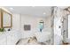 Bright bathroom featuring a double sink vanity, soaking tub, glassed in shower and marble floors at 501 Sportsman Park Dr, Seffner, FL 33584
