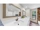 Elegant bathroom with dual sinks, a framed mirror, and modern fixtures at 501 Sportsman Park Dr, Seffner, FL 33584