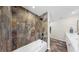 Modern bathroom showcasing a luxurious bathtub and stunning stone tile shower at 501 Sportsman Park Dr, Seffner, FL 33584