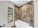 Updated bathroom features a soaking tub with stone tile accents at 501 Sportsman Park Dr, Seffner, FL 33584
