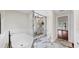 Bathroom featuring a soaking tub, glass enclosed shower with marble walls and floors at 501 Sportsman Park Dr, Seffner, FL 33584