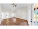 Large bedroom with a ceiling fan, bright windows, and hardwood floors at 501 Sportsman Park Dr, Seffner, FL 33584